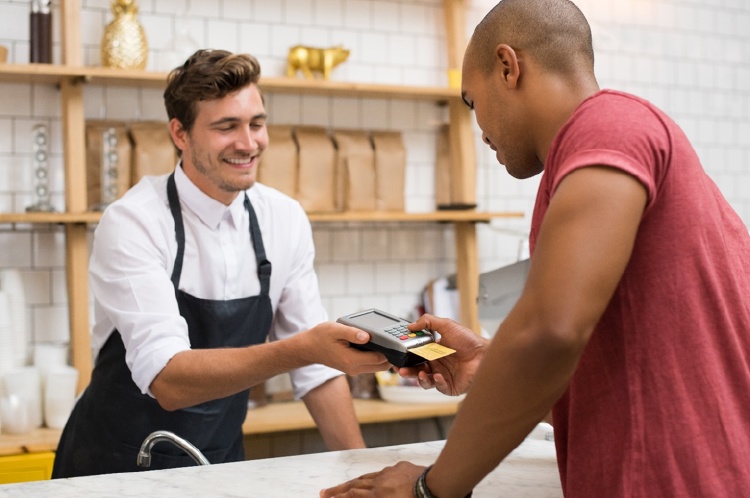 customer paying waiter with credit card